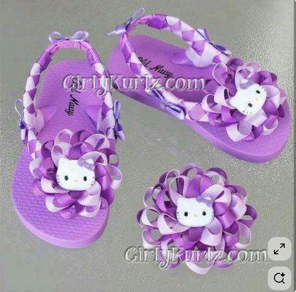 Purple woven sandals with Hello Kitty design on a gray background