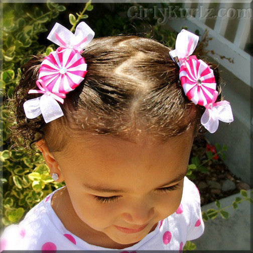 Girl wearing handmade peppermint candy hair clip - festive ribbon bow accessory